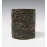 A Chinese bronze brushpot, 20th century, the cylindrical body cast in relief with goats between