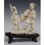 A Japanese carved ivory okimono figure group, early 20th century, modelled as father and son