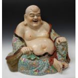 An impressive Chinese famille rose porcelain figure of a smiling Buddha, 20th century, modelled in a