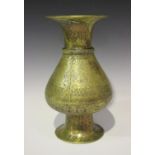 A Khorasan brass vase, the pear shaped body and flared neck engraved with foliate medallions and