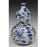 A Chinese blue and white porcelain double gourd vase, mark of Qianlong but modern, painted with