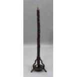 A Chinese hardwood lamp standard, 20th century, the column carved in relief with prunus, on a