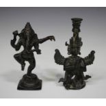 An Indian dark brown patinated bronze figure of Ganesh, early 20th century, modelled standing on one