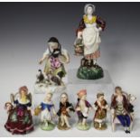 A Meissen porcelain figure group, late 19th century, modelled as a young girl standing feeding a