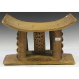 An Ashanti carved wooden stool with a rectangular base, height 34cm, width 53cm.Buyer’s Premium 29.