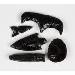 A small group of chipped obsidian artifacts, including two arrowheads, one inscribed 'Azcapuzalco