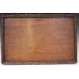 A Chinese hardwood rectangular tray, late Qing dynasty, carved with naturalistic bamboo border,