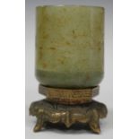 A Chinese small jade cup, early 20th century, of cylindrical form, carved in low relief with a