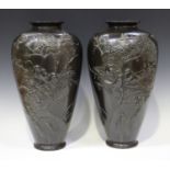 A pair of Japanese brown patinated bronze vases, Meiji period, of shouldered tapering form, each
