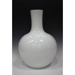 A Chinese white glazed porcelain bottle vase (tianqiuping), modern, the globular body with