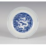 A Chinese blue and white reverse-decorated 'dragon' saucer dish, mark of Daoguang but possibly