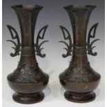 A pair of Japanese brown patinated bronze vases, Meiji period, each low-bellied body cast with