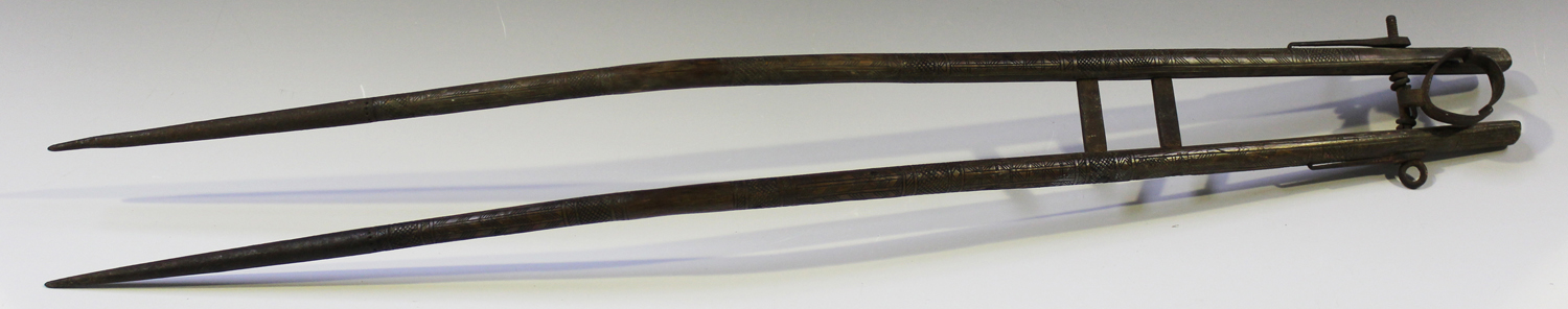 A Tibetan matchlock musket bipod stand, probably 19th century, formed as a pair of hardwood horns