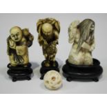 A group of three Japanese carved and stained ivory netsuke, Meiji/Taisho period, comprising father