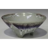 A Japanese studio pottery bowl, 20th century, the conical body with a streaky flambé glaze, on