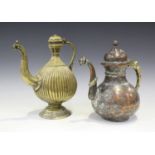 An Indian Mughal brass ewer, 18th/19th century, the vertically ribbed tear shaped body with domed