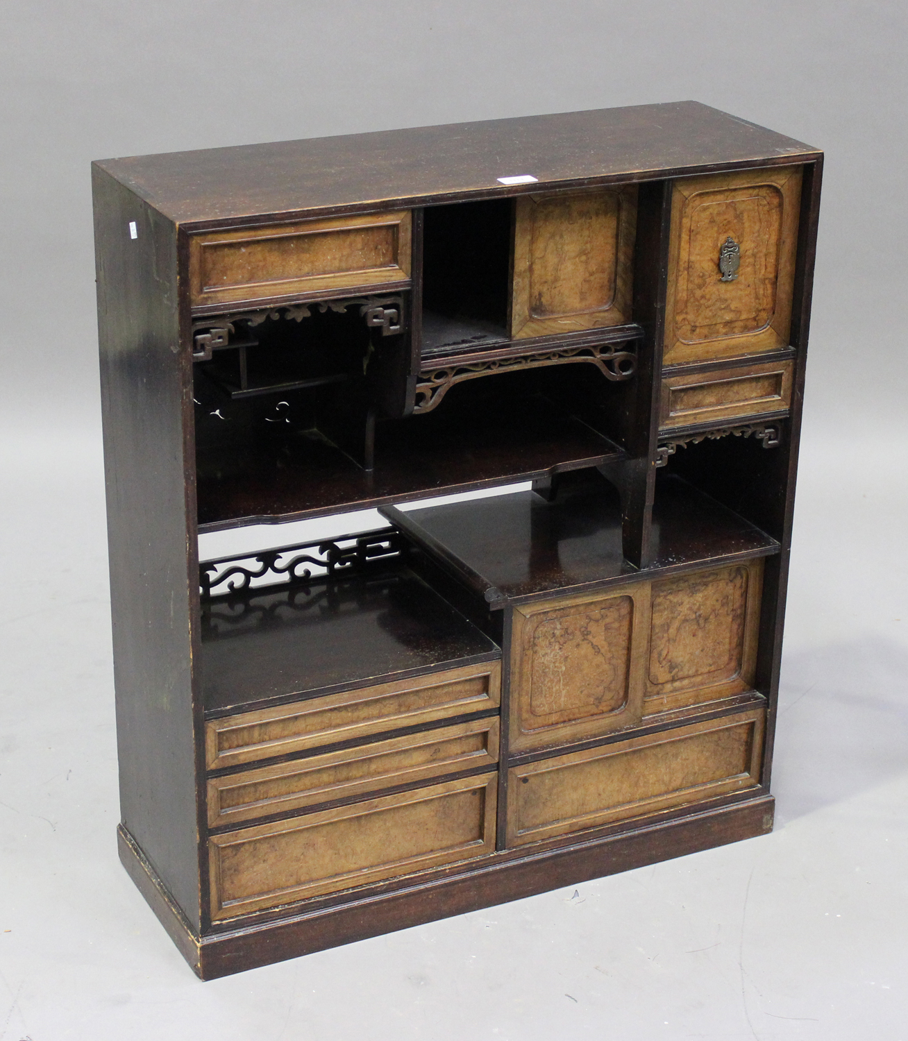 A Japanese hardwood display shelf, Meiji period, the rectangular top above an arrangement of