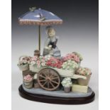 A Lladro porcelain figure group Flowers of the Season, model No. 1454, signed to base, with stand,