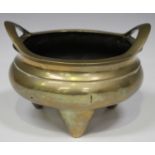 A Chinese polished bronze tripod censer, mark of Xuande but early 20th century, of circular bombé