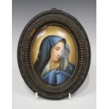 An oval Continental porcelain plaque, late 19th century, painted with a bust portrait of the