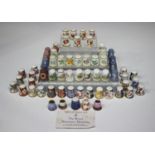 Nine Royal Worcester porcelain thimbles, mid-20th century, each painted with flowers, signed by