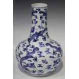 A Chinese blue and white porcelain bottle vase, late 19th century, painted with dragons amidst