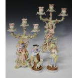 A pair of Sitzendorf porcelain three-branch candelabra, circa 1900, modelled as a maiden and
