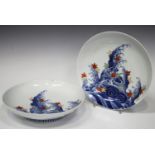 A pair of Japanese Nabeshima circular dishes, 19th century, each painted in underglaze blue with a