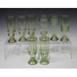 Eight pale green tinted Powell type drinking glasses, 20th century, each of tapered cylindrical