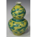 A Chinese yellow and green glazed porcelain double gourd shaped vase, mark of Guangxu but possibly