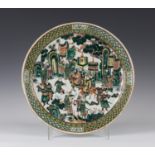 A Chinese famille verte porcelain circular dish, late 19th century, painted with a scene of an