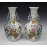 A pair of Chinese famille rose vases, each body and flared narrow neck enamelled with a pair of