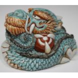 A Japanese Arita porcelain figure of a coiled dragon, 19th century, the turquoise scaled beast