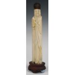 A Chinese carved ivory figure of an immortal, probably Ming dynasty, modelled wearing a long robe