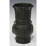 A Chinese archaistic brown patinated bronze vase, Ming style but Qing dynasty, the oval body and