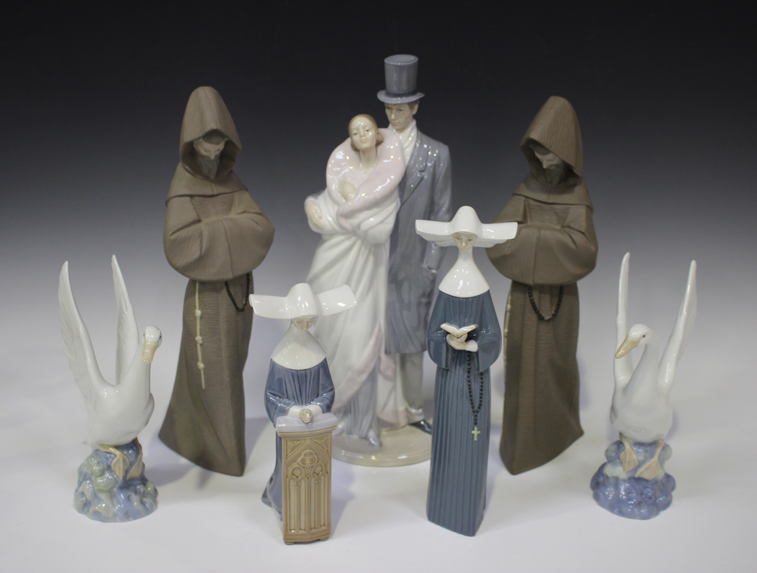 Two Lladro Gres stoneware figures of monks, model No. 2060, together with two Lladro nuns,