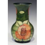 A Moorcroft pottery vase, circa 1990, decorated in the Rose pattern against a green ground, designed