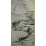 A Chinese hanging scroll painting, 20th century, depicting a river landscape, lines of black text