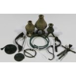 A small collection of bronze antiquities, including Roman fibula brooches, a bangle and three