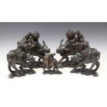 A pair of Chinese wire inlaid hardwood carvings of boys on water buffalo, early 20th century, each