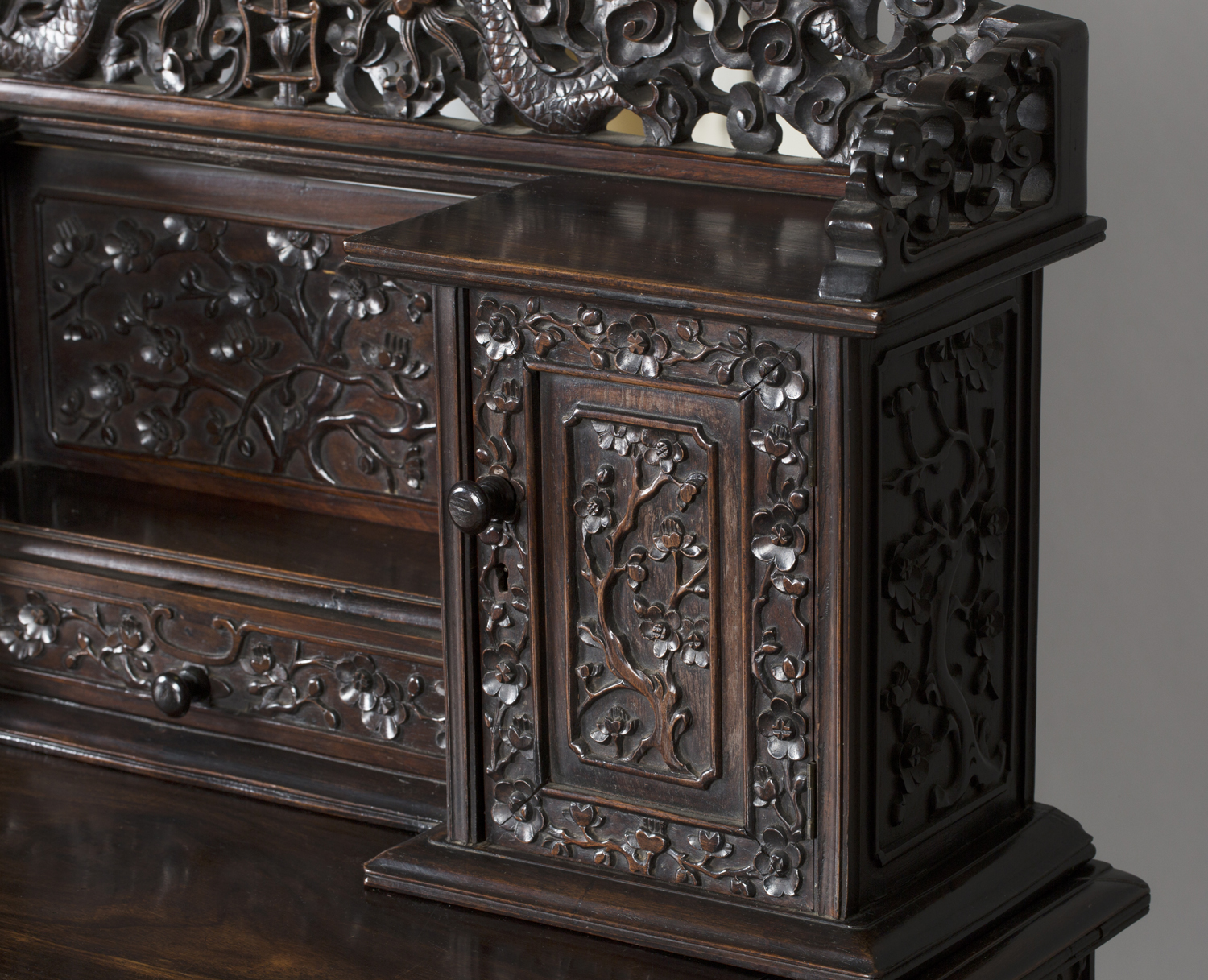 A Chinese hardwood writing desk with carved blossoming prunus decoration, late 19th century, the - Image 13 of 14