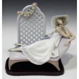 A Lladro porcelain figure group Garden of Dreams, model No. 7634, signed to base, with stand,