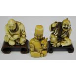 A group of three Japanese carved and stained ivory netsuke, Meiji/Taisho period, comprising three