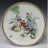 A Chinese famille rose porcelain circular dish, late 20th century, painted with a figural scene of a