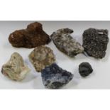 A group of seven mineral specimens, including a formation of 'Black Phantom' quartz and other quartz