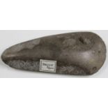 An Irish Neolithic polished stone axe head, bearing label inscribed 'Ireland R.S. Coll' and detailed