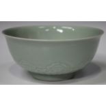 A Chinese celadon glazed porcelain circular bowl, mark of Tongzhi but probably later, the exterior