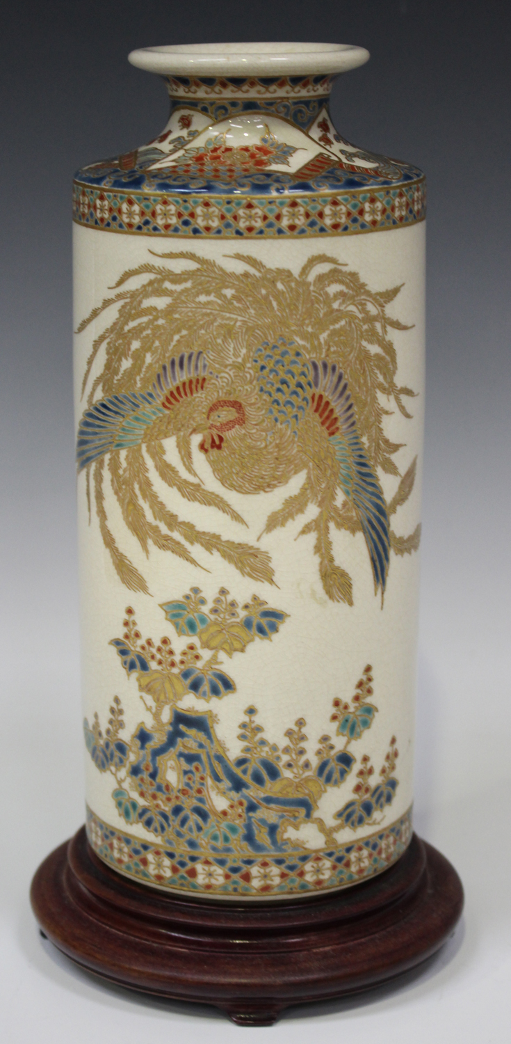 A Japanese Satsuma earthenware cylinder vase, Meiji period, thickly enamelled and gilt with a ho-o