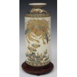 A Japanese Satsuma earthenware cylinder vase, Meiji period, thickly enamelled and gilt with a ho-o