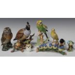 A mixed group of porcelain birds, 20th century, including a Goebel canary perched on a tree stump, a